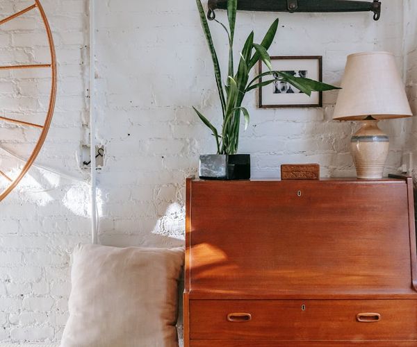 Cozy corner of a room with a yoga mat, a plant, and soft morning light.